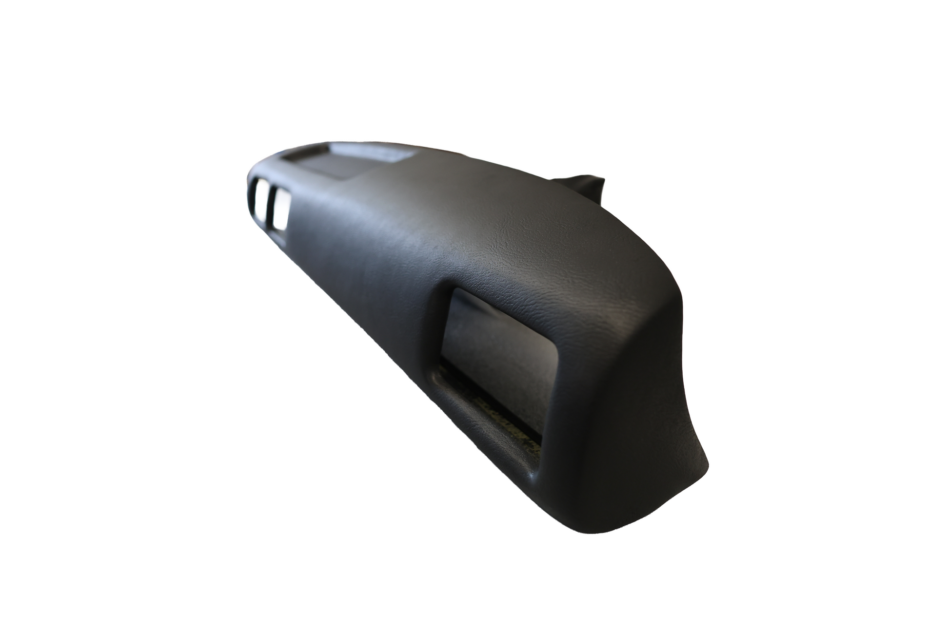 High-angle perspective view of the black Just Dashes SoftCap padded dash cover for 1987-1988 Toyota Pickup and 4Runner, showing the side thickness and contoured fitment.